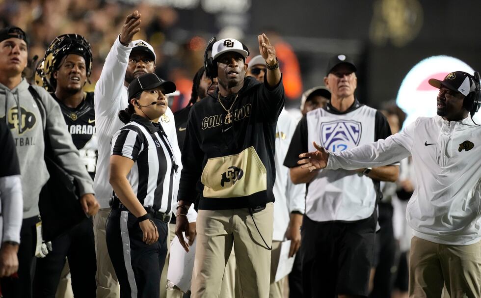 Colorado head coach Deion Sanders, center, complains about a call in the second half of an...