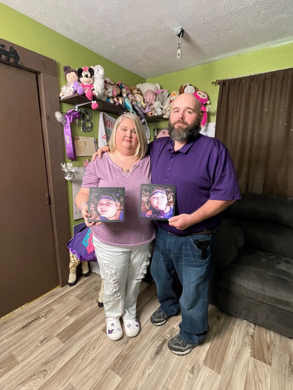 Sarah and Keith Streeval stand in front of a memorial to their daughter, Bella, who died in...