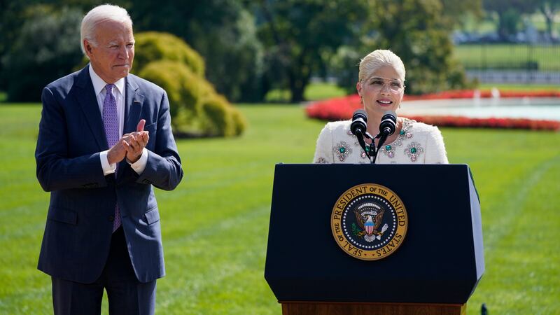 President Joe Biden applauds as actress Selma Blair speaks during an event to celebrate the...