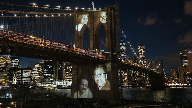 New Yorkers who died during the coronavirus pandemic are projected onto the Brooklyn Bridge...