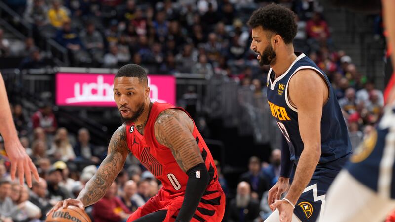 Portland Trail Blazers guard Damian Lillard, left, drives past Denver Nuggets guard Jamal...