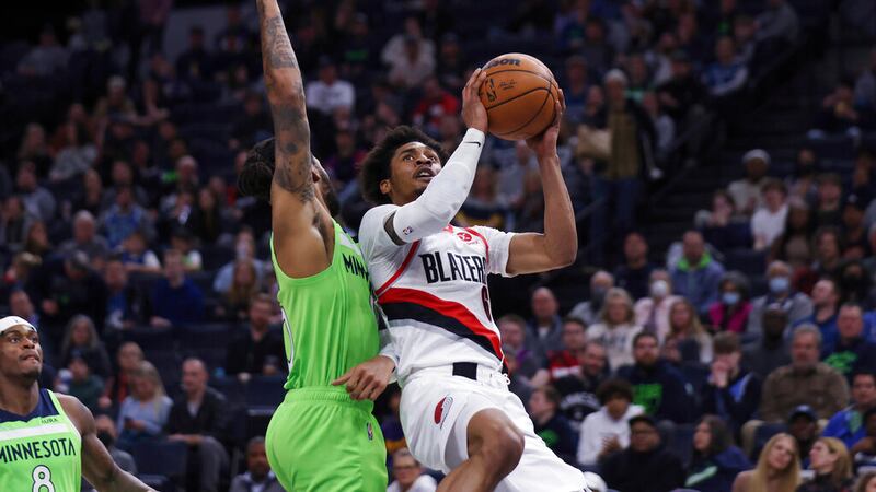 Portland Trail Blazers guard Keon Johnson (6) goes up to the basket next to Minnesota...