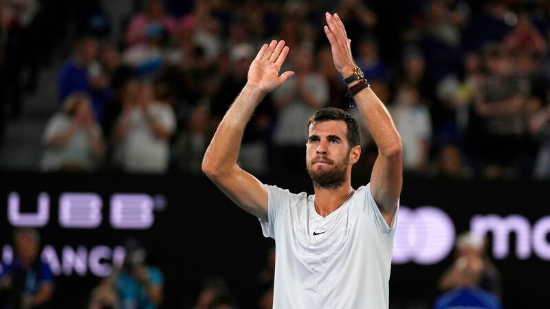 Karen Khachanov of Russia waves after Sebastian Korda of the U.S. withdrew their quarterfinal...