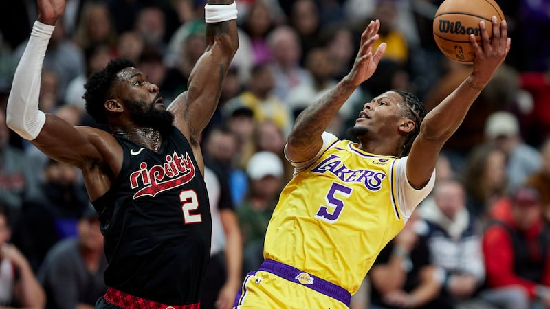 Los Angeles Lakers forward Cam Reddish shoots against Portland Trail Blazers center Deandre...