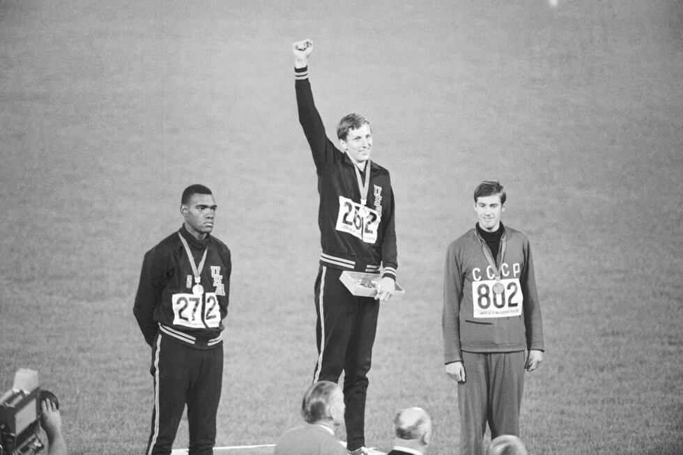 FILE - Gold medal winner Dick Fosbury raises his arm on the victor's podium of the Olympic...