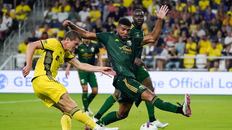 Nashville SC's Luke Haakenson, left, shoots past Portland Timbers' Zac McGraw during the first...
