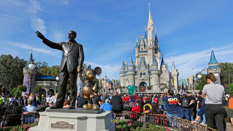 FILE - In this Jan. 9, 2019 photo, guests watch a show near a statue of Walt Disney and Micky...
