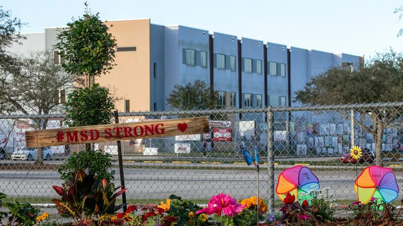 FILE - A memorial to the victims is seen outside Marjory Stoneman Douglas High School in...