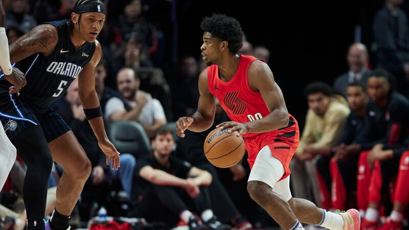 Portland Trail Blazers guard Scoot Henderson, right, dribbles toward Orlando Magic forward...