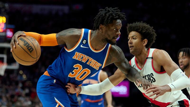 New York Knicks forward Julius Randle, left, dribbles towards Portland Trail Blazers guard...