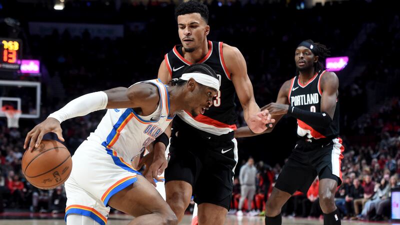 Oklahoma City Thunder guard Shai Gilgeous-Alexander, left, drives to the basket against...