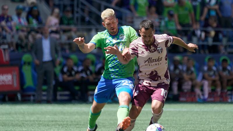 Portland Timbers midfielder Sebastian Blanco (10) is challenged by Seattle Sounders midfielder...