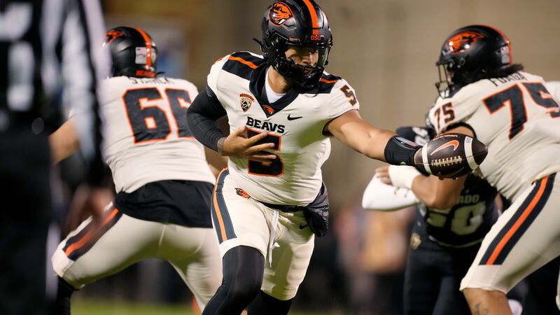 Oregon State quarterback DJ Uiagalelei hands the ball off during the first half of the tem's...