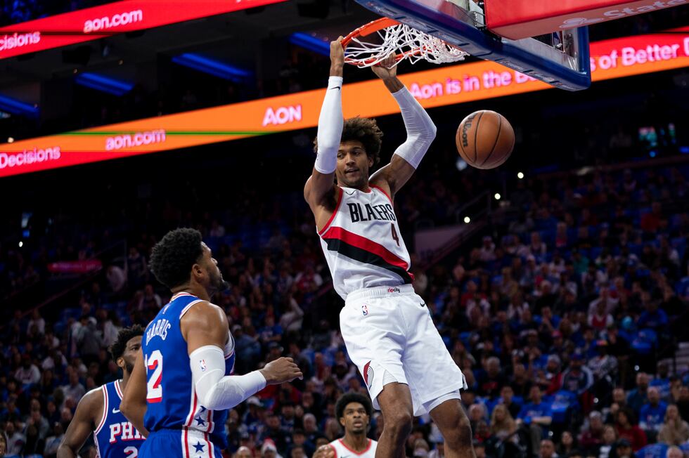 Portland Trail Blazers' Matisse Thybulle, right, dunks the ball as Philadelphia 76ers' Tobias...
