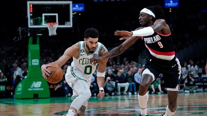 Boston Celtics forward Jayson Tatum (0) drives to the basket against Portland Trail Blazers...