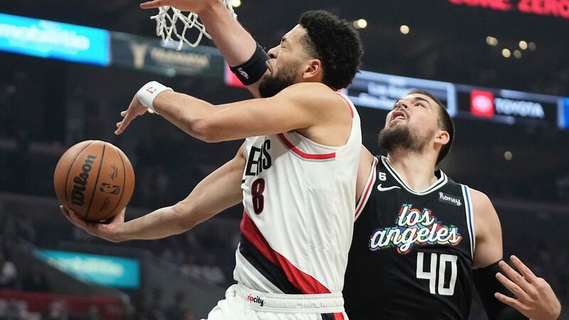 Portland Trail Blazers guard Skylar Mays, left, shoots as Los Angeles Clippers center Ivica...