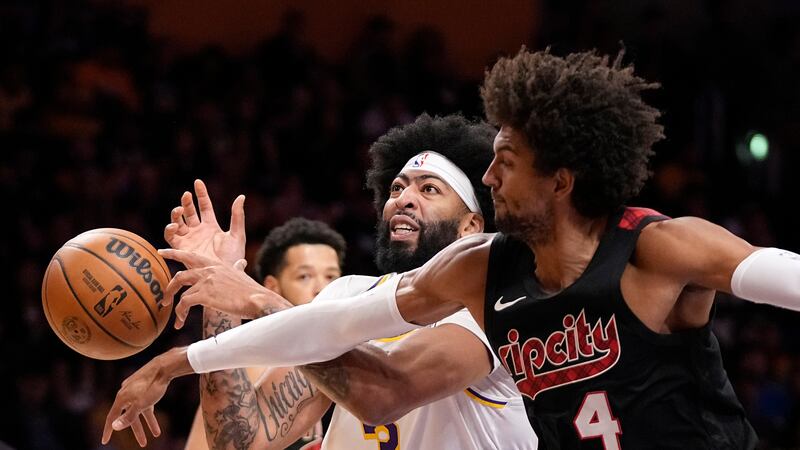 Portland Trail Blazers guard Matisse Thybulle, right, knocks the ball from the hands of Los...