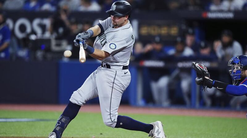 Seattle Mariners' Cal Raleigh hits an RBI single against the Toronto Blue Jays during the...